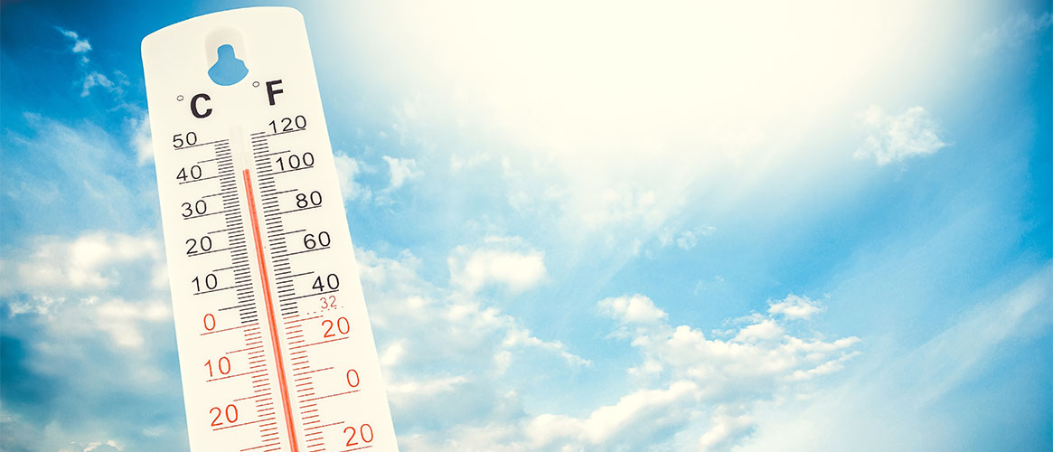 A thermometer in a blue sky background