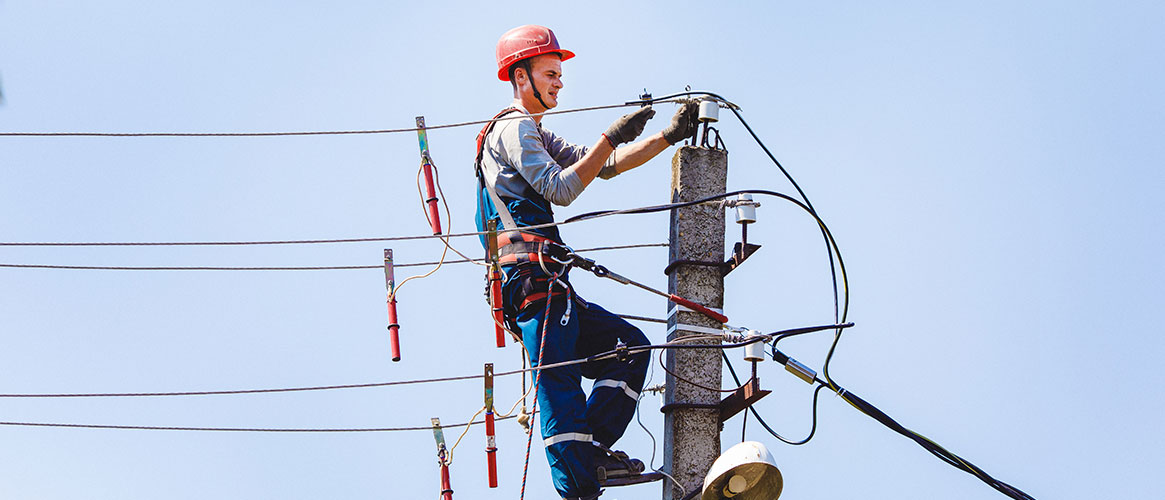 Utility worker using PPE while working on an electrical power line