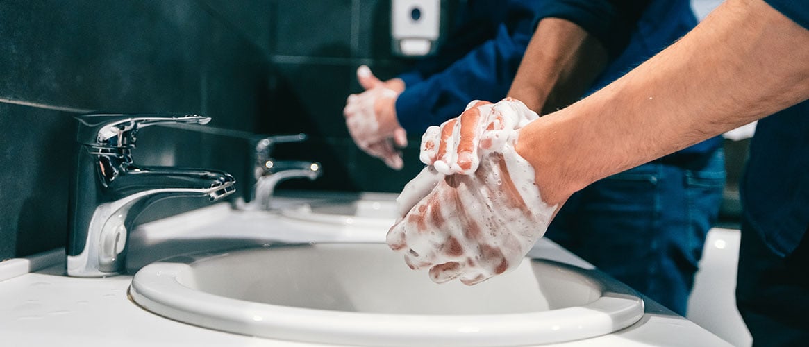 Workers using good personal hygiene by thoroughly washing their hands