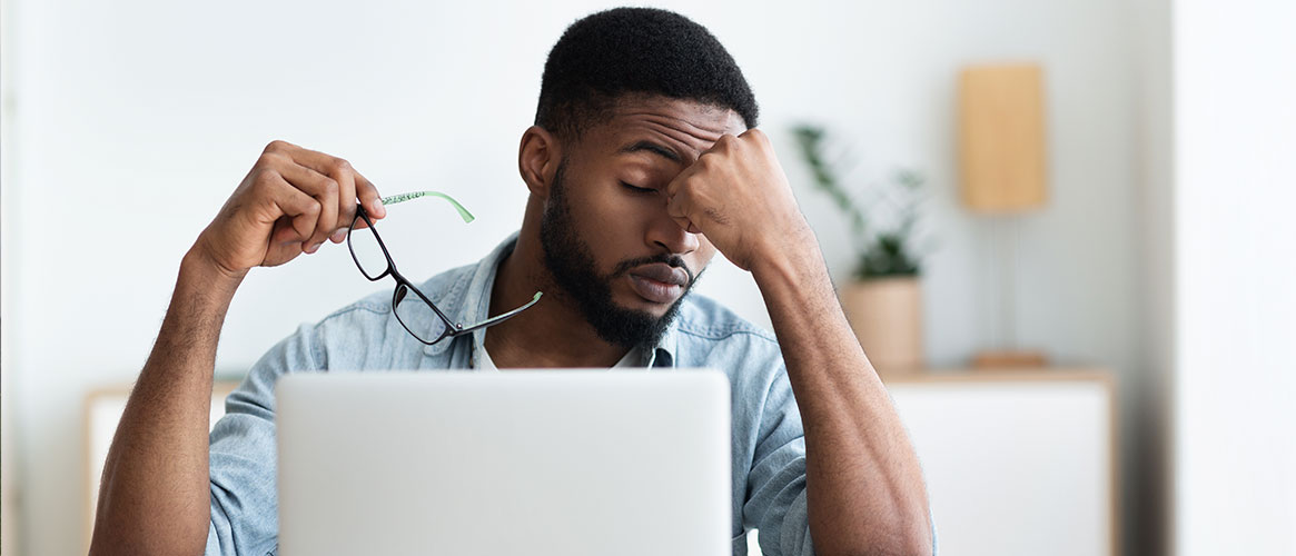 person working on computer suffering from eye strain